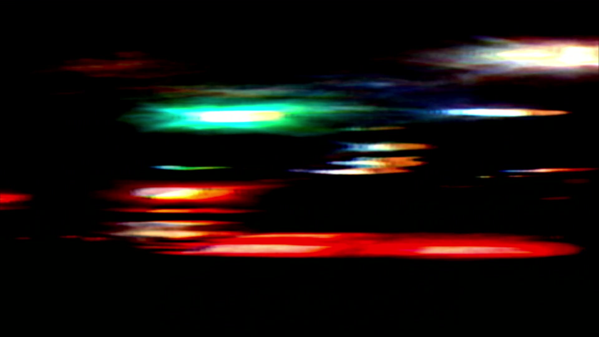 Vibrant video loop of abstract streaks of colorful city lights against a dark background.