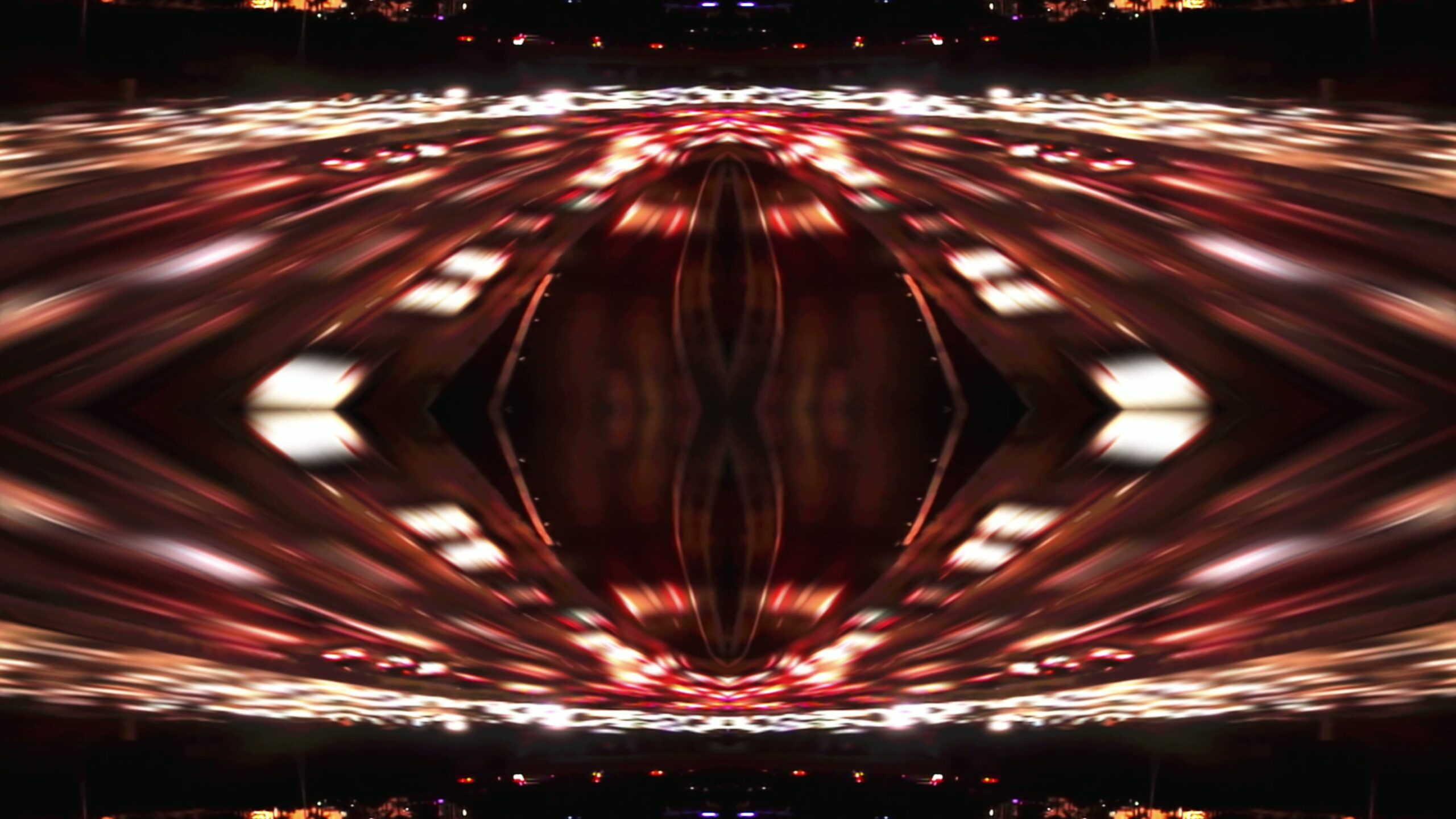 Abstract 4K video loop of symmetrical light trails creating a vibrant nightscape.