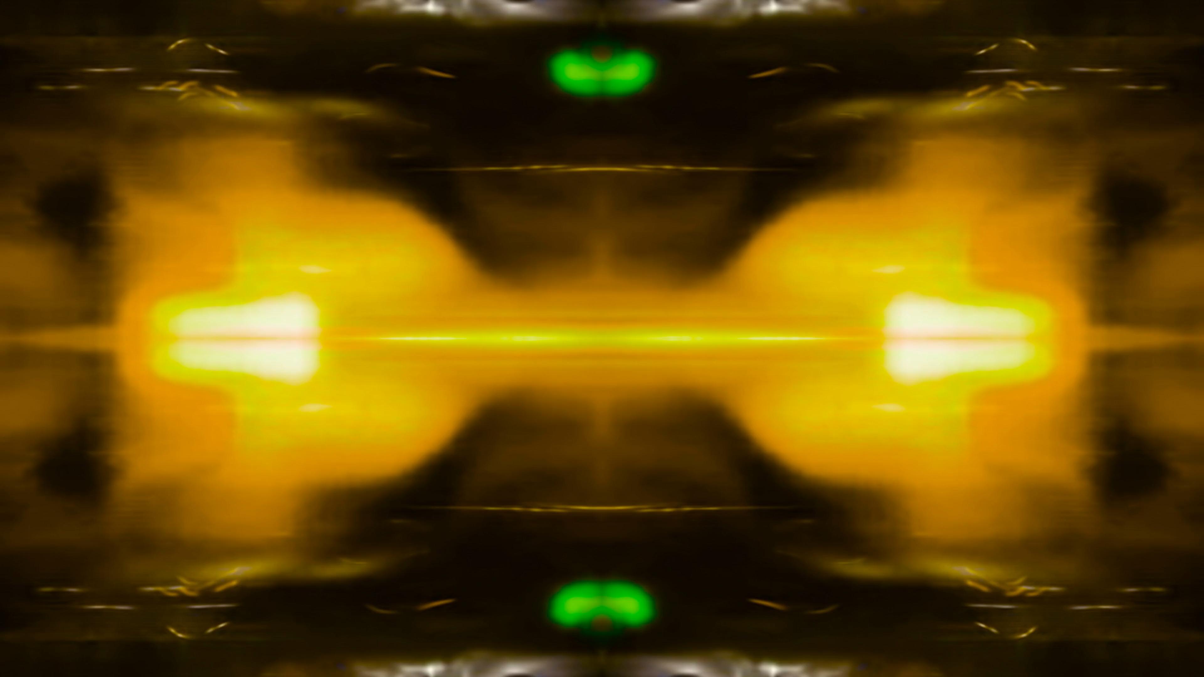 Abstract symmetrical patterns with dominant yellow hues and subtle hints of green and pink, creating a calm and harmonious aura.