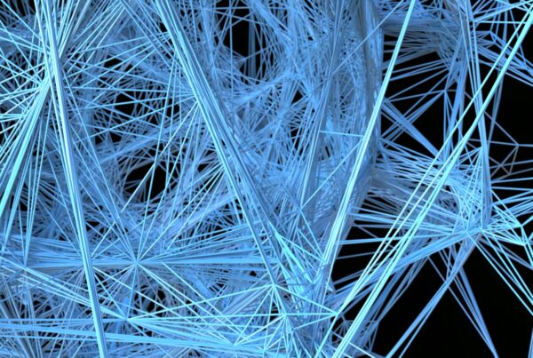A complex network of intersecting blue lines forming an intricate mesh against a black background, creating a visually striking abstract representation of connectivity and modern technology.