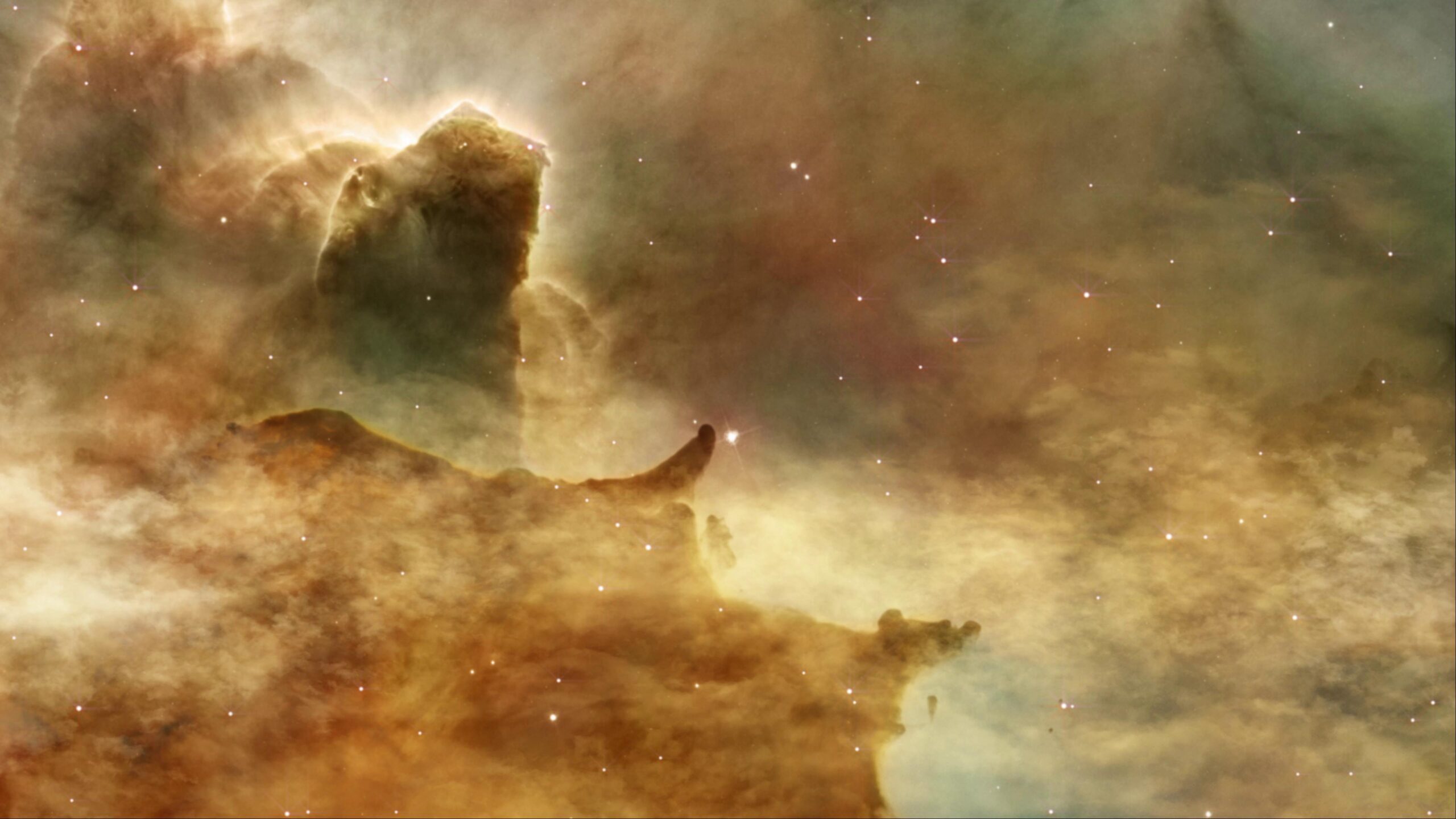 Stellar nursery nebula with glowing pillars and sparkling stars.