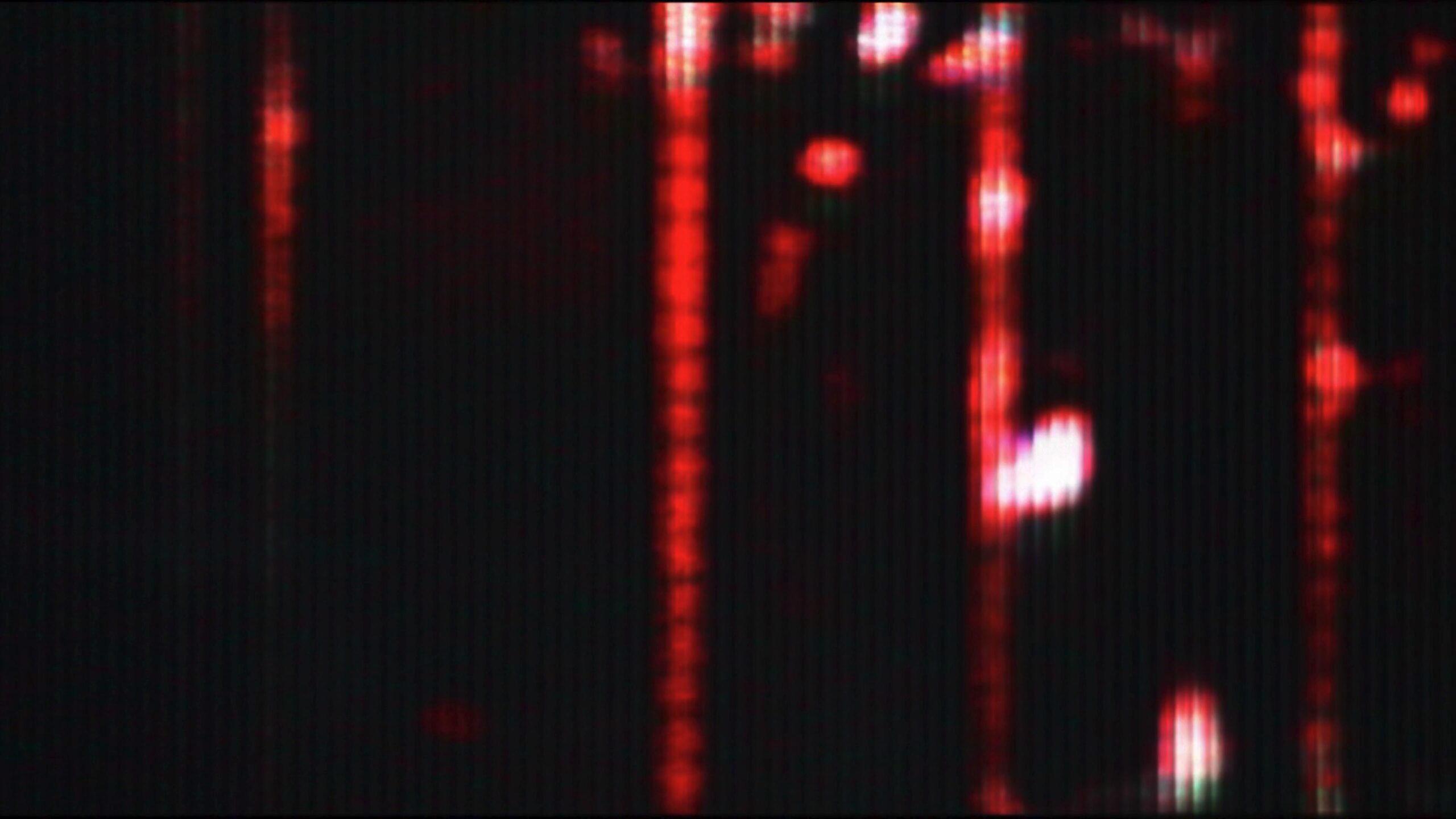 Close-up 4K looping video of a colorful pixel grid animation with red, green, and blue hues, forming an intricate animated display.
