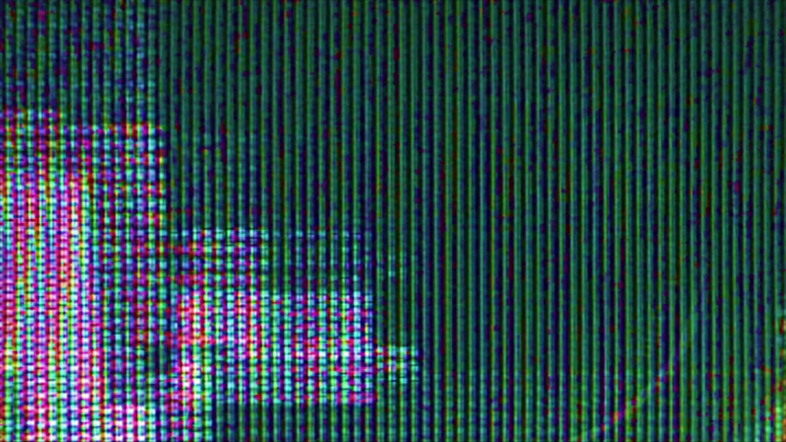 Close-up 4K video loop of a digital screen showing RGB color noise patterns with vertical lines and pixelated design.