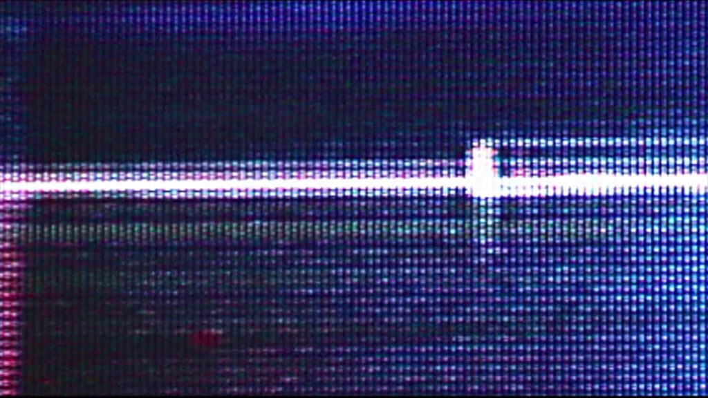 Pixelated glitch effect with 'ON' text appearing amidst red-green distortions.