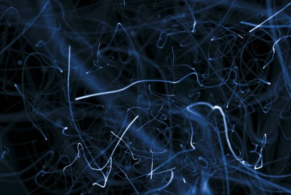 Abstract video loop with chaotic blue light trails against a dark background, resembling an intricate network or a starry night.