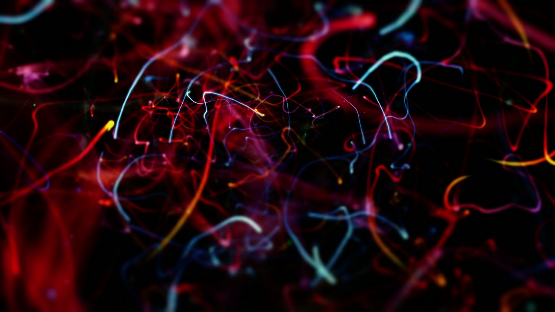 Vibrant abstract looping video of light trails in red, blue, and yellow creating a dynamic and colorful web against a dark video background, showcasing movement and energy.