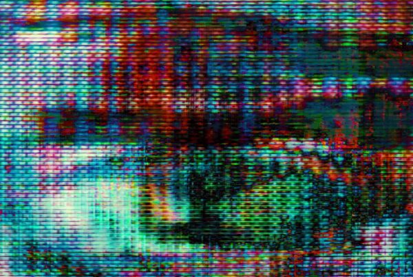 The 4K video loop depicts a glitchy digital animation with vibrant hues swirling across an abstract screen.