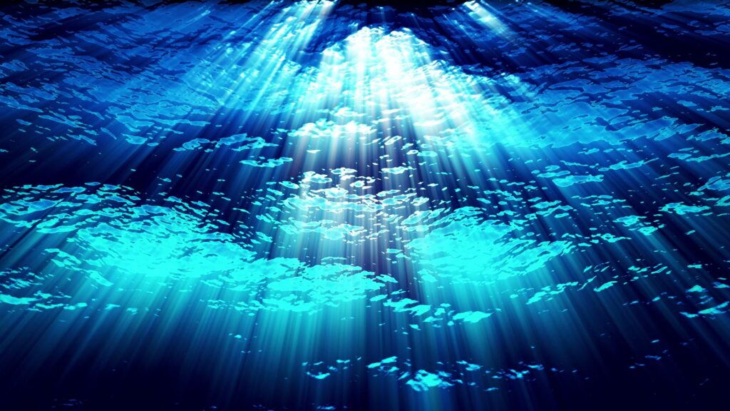 Ocean underwater scene with bright, refracting sunlight. Video animation loop.