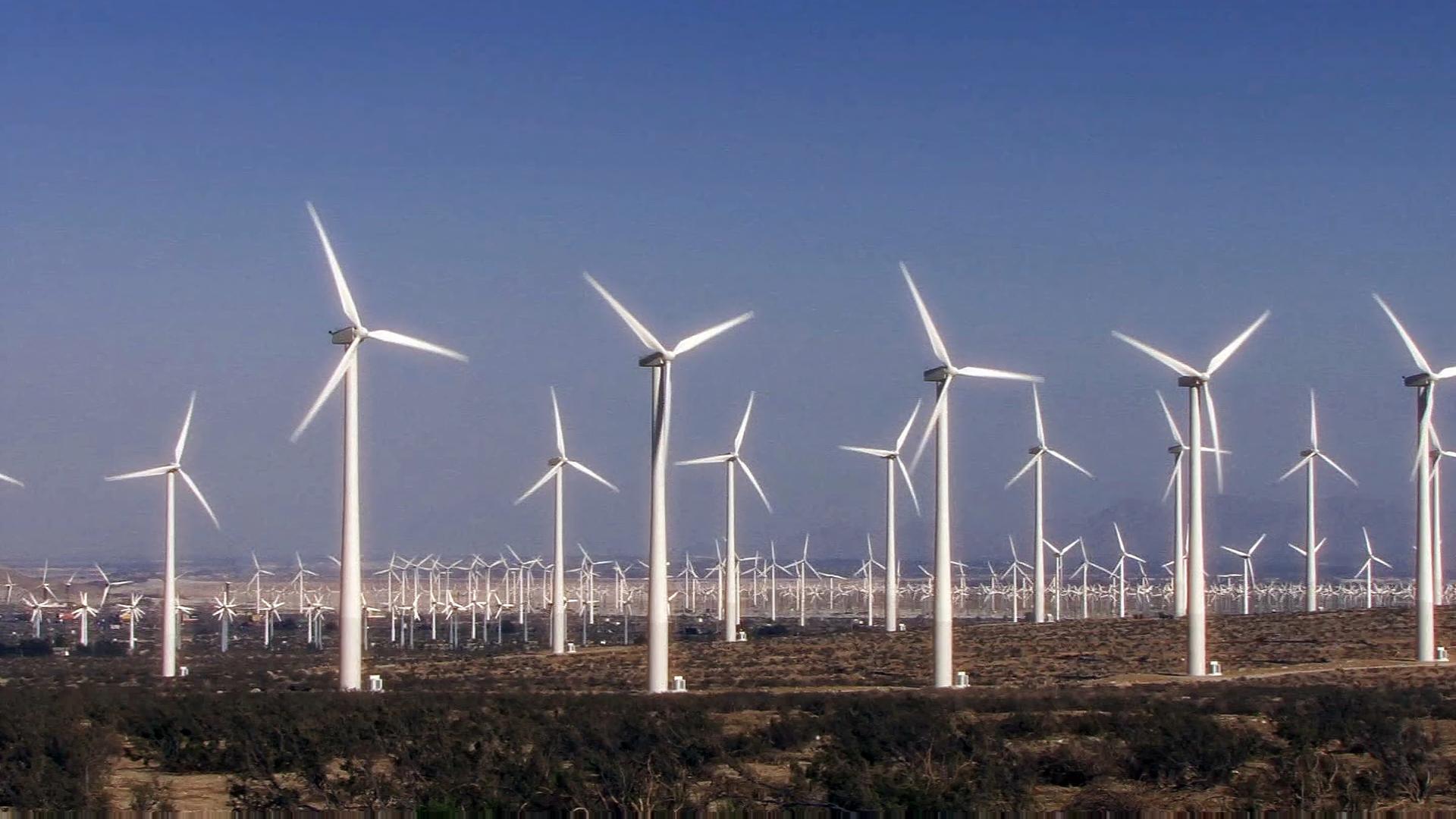 Free HD video of operational wind turbines generating green energy in open desert plains