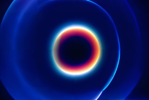 A mesmerizing abstract image of concentric glowing circles with vibrant colors against a dark background.