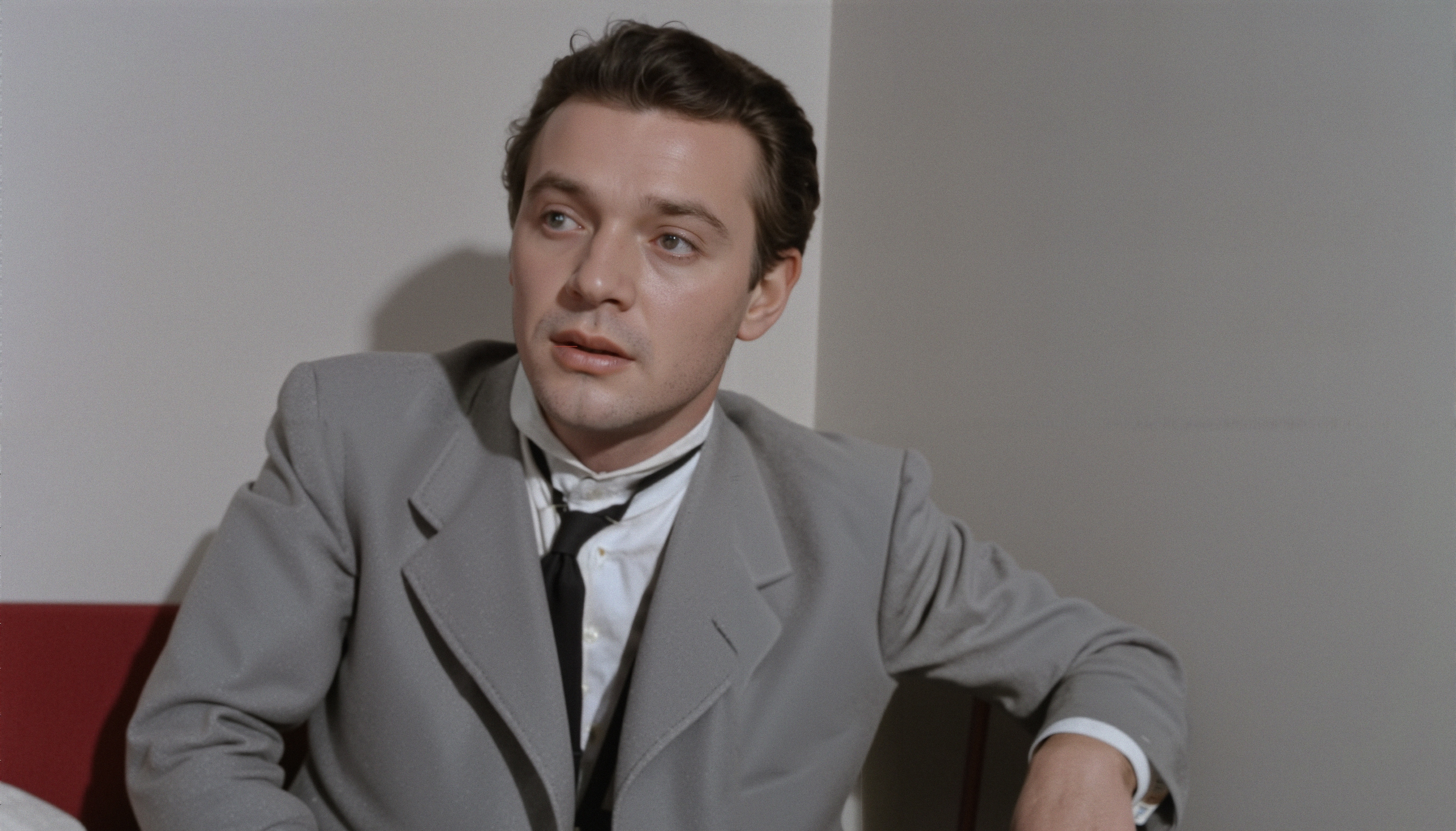 Contemplative Man in Gray Suit