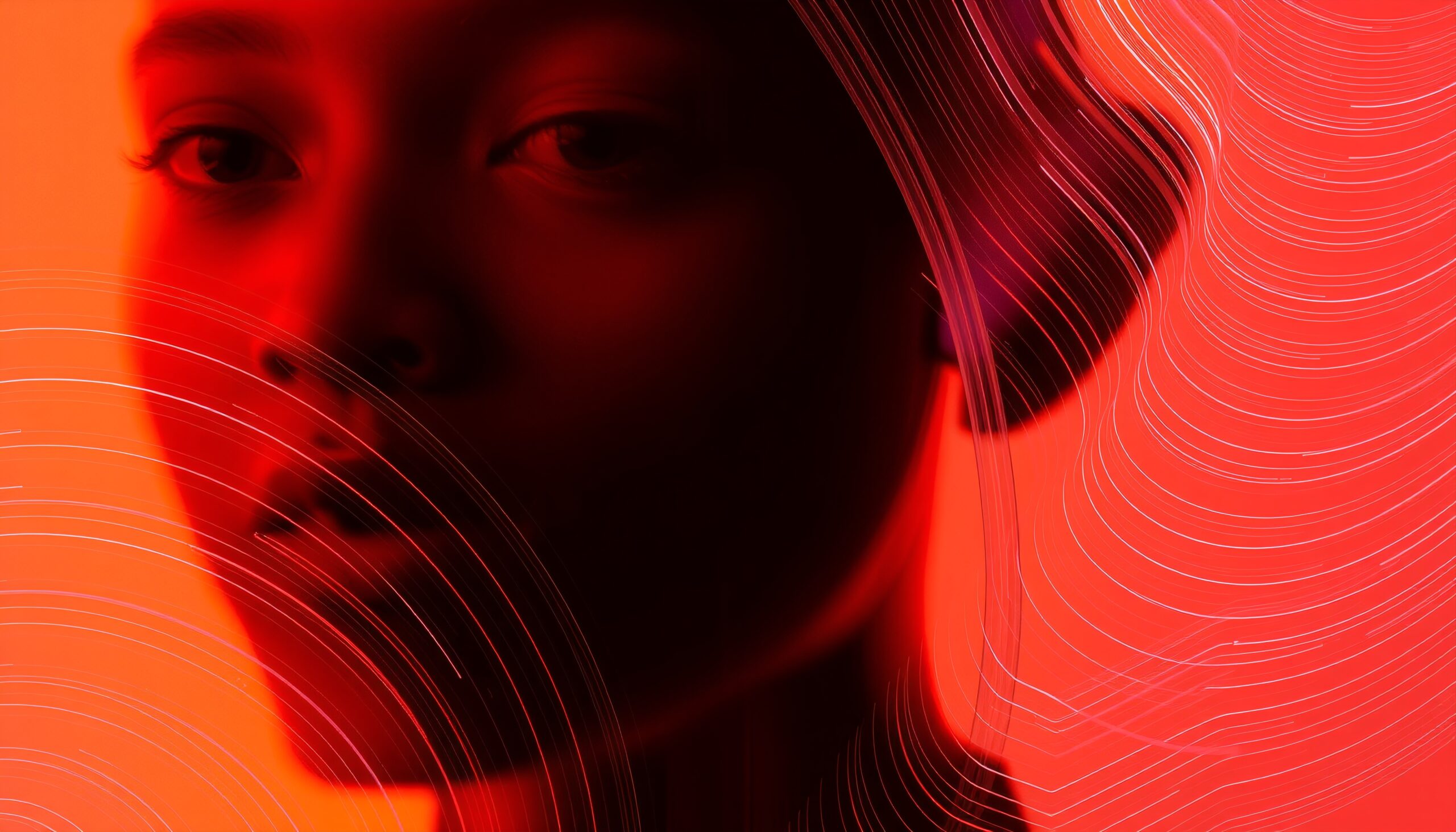 A woman's face in red shadow with abstract lines.