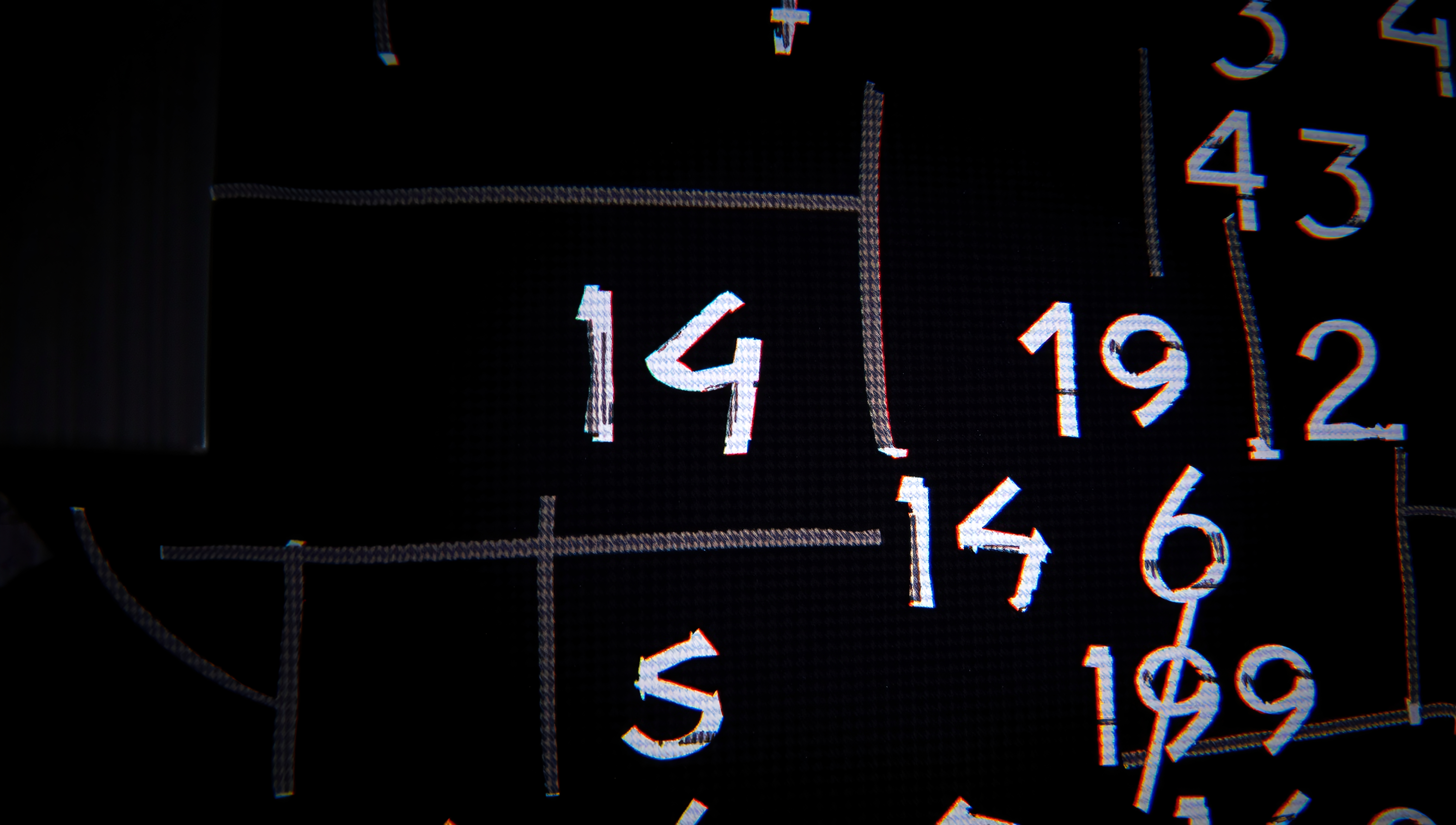 A chaotic grid of various chalk-drawn numbers overlapping and intertwining on a dark background.