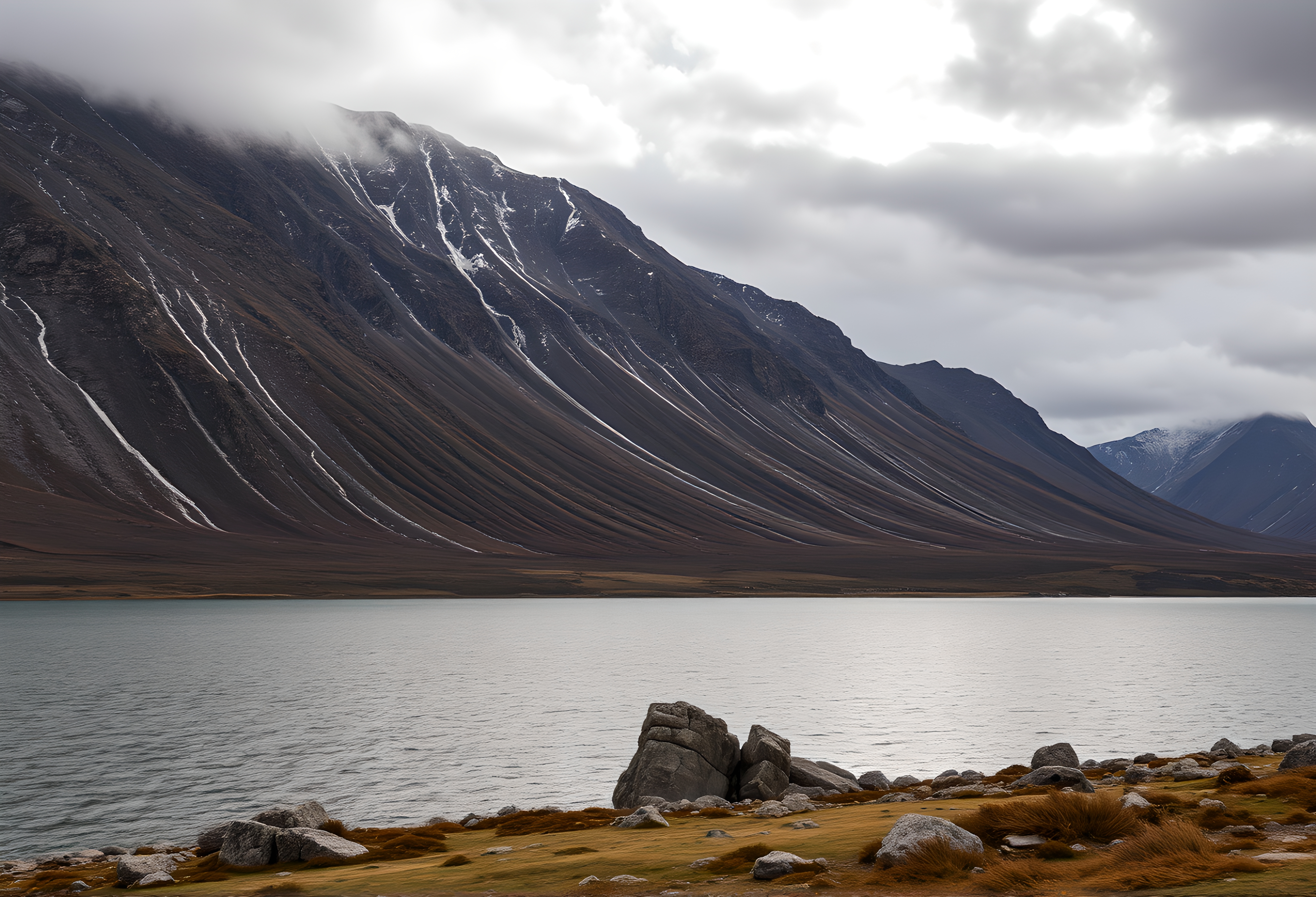 Dramatic glacial fjord landscape with steep mountain slopes unde