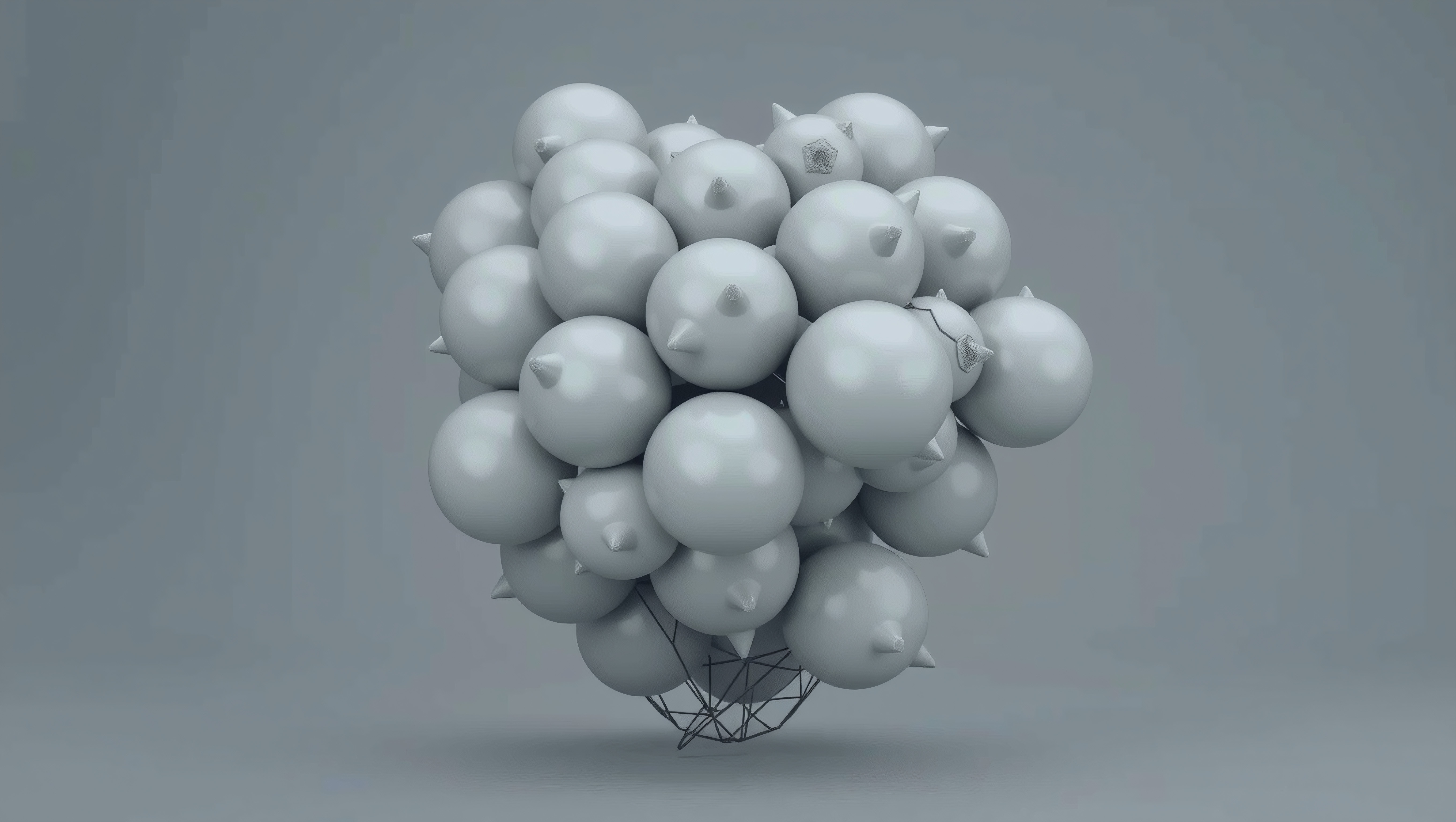 Cluster of metallic spheres with conical spikes on a gray background.