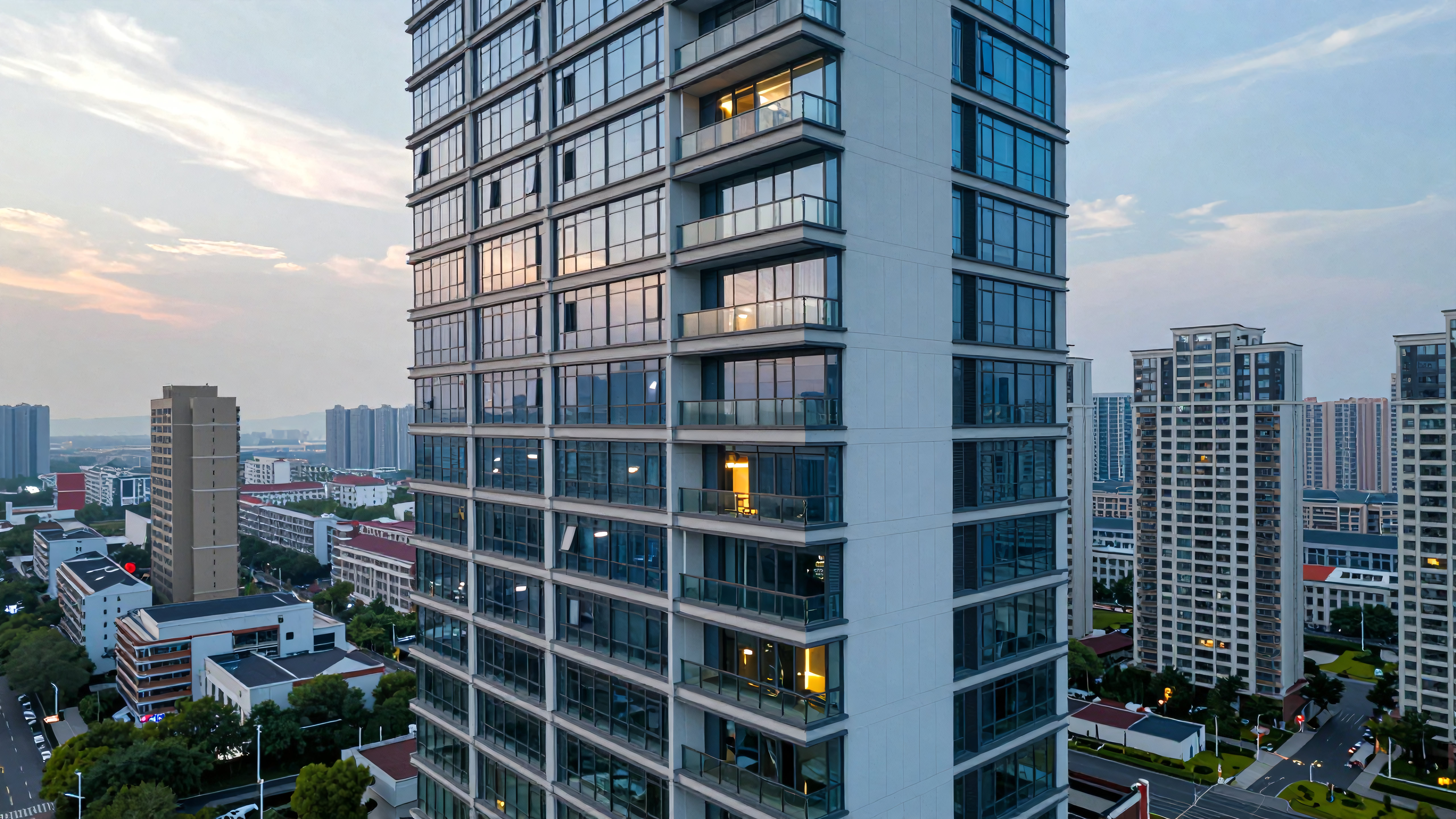 Modern high-rise apartment building with illuminated windows during beautiful twilight cityscape