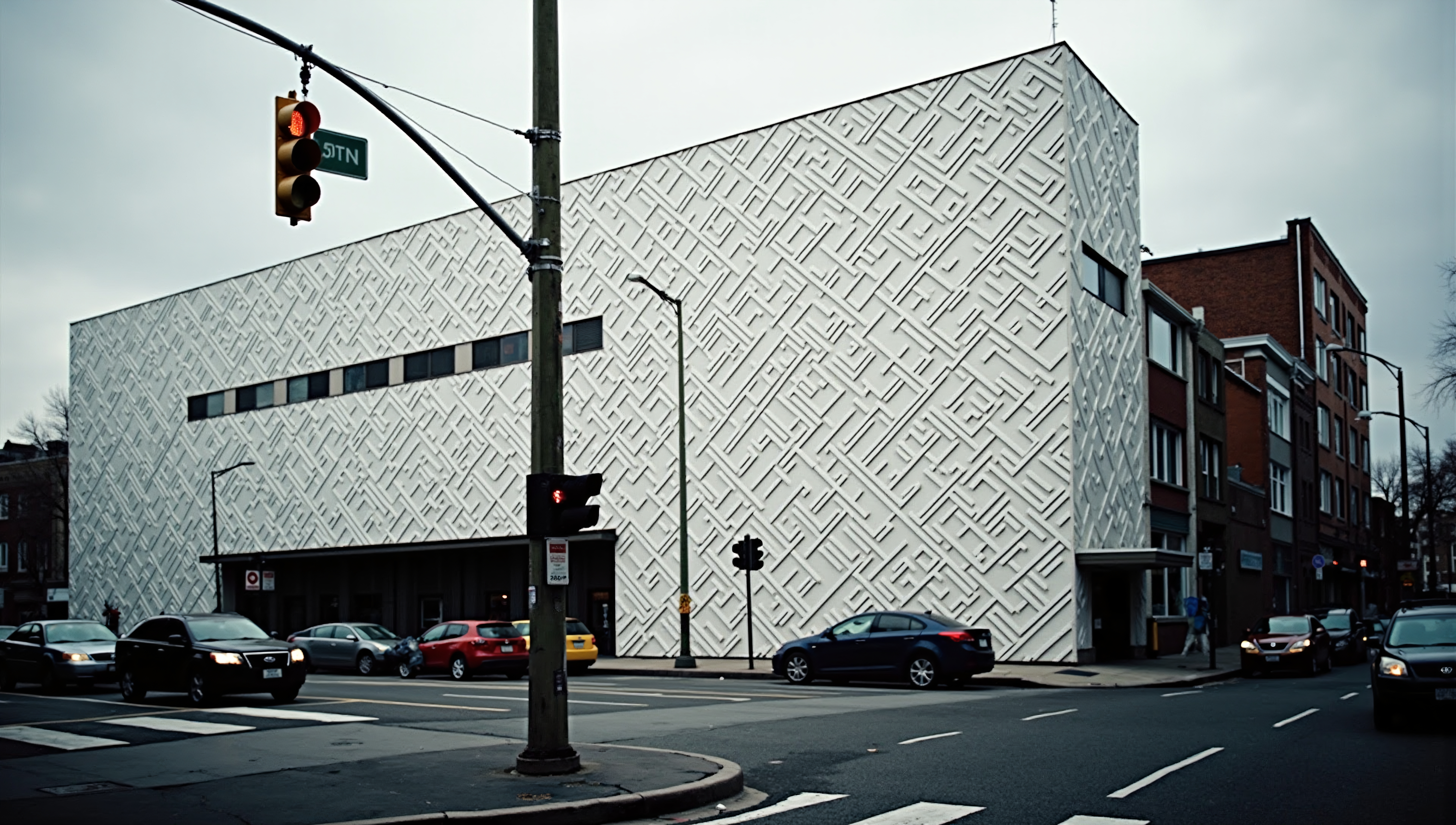 Modern urban building with geometric patterned facade and street scene.