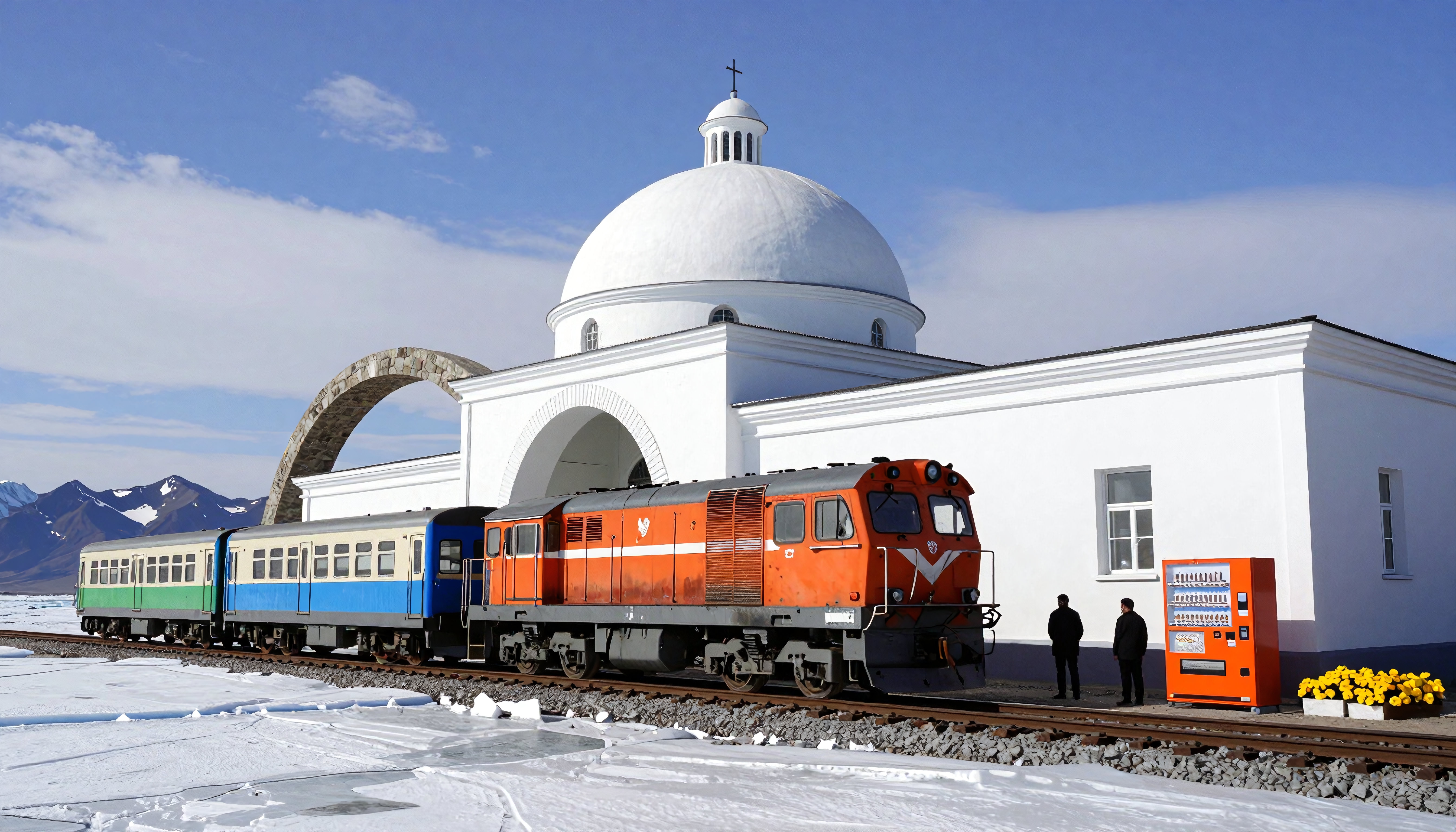 Orange train and white domed building in snowy mountain landscape.