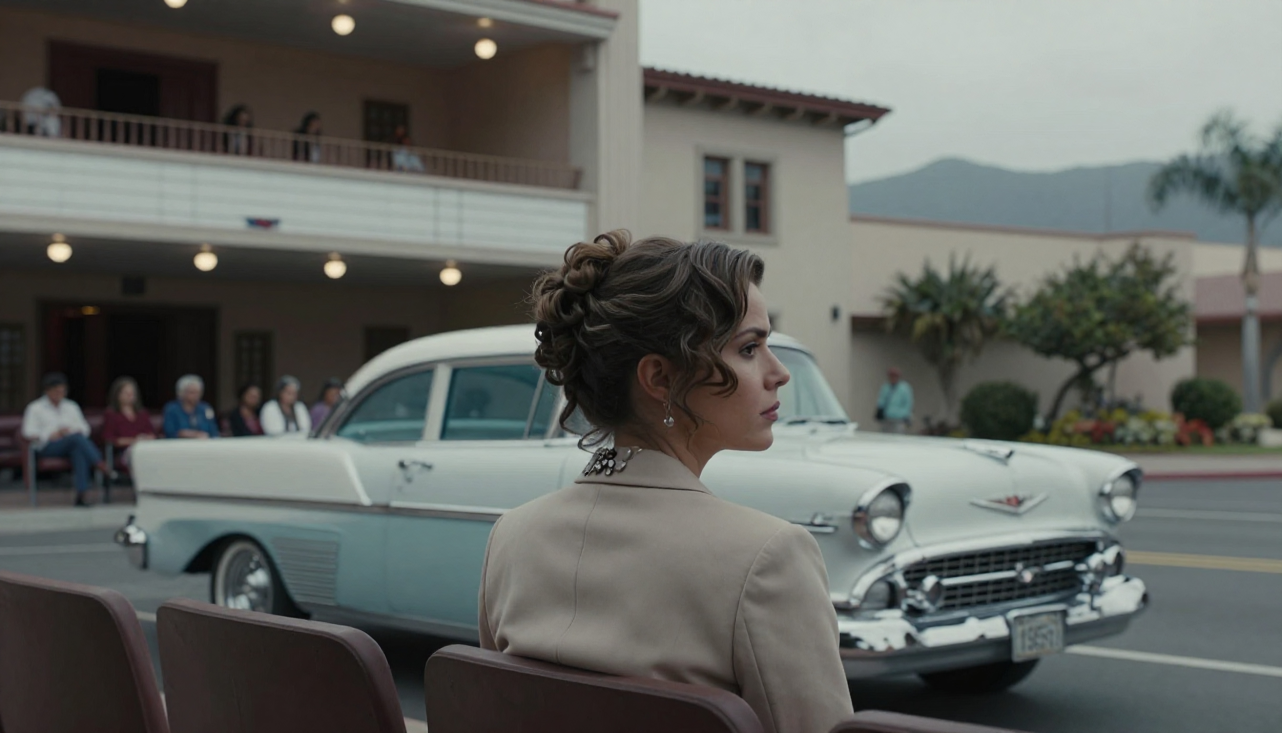 Woman sitting before vintage car, gazing thoughtfully.