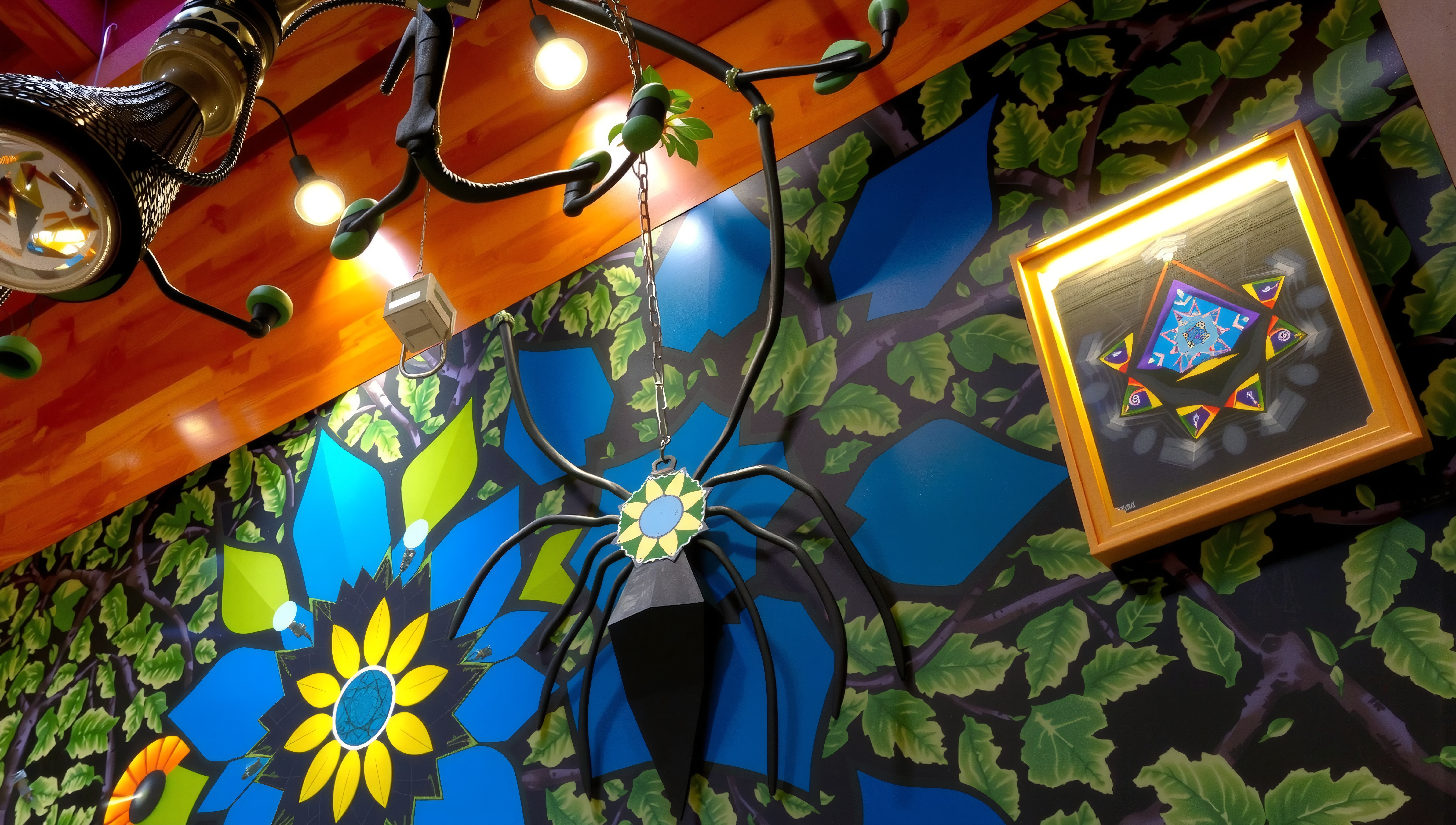 A vibrant room with a spider-like chandelier, blue floral mural, and illuminated geometric artwork.