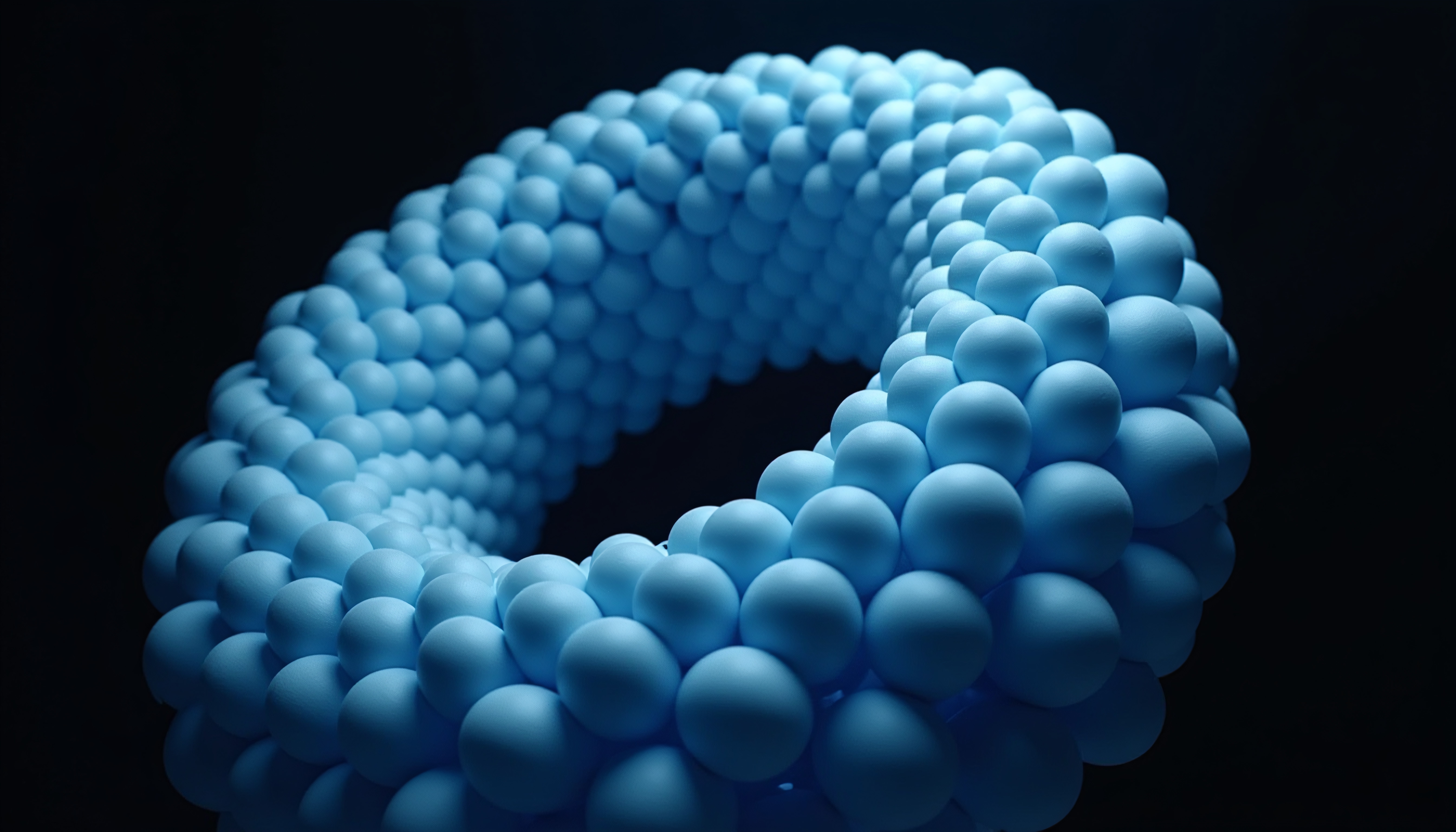 Abstract blue spheres forming torus-shaped structure.