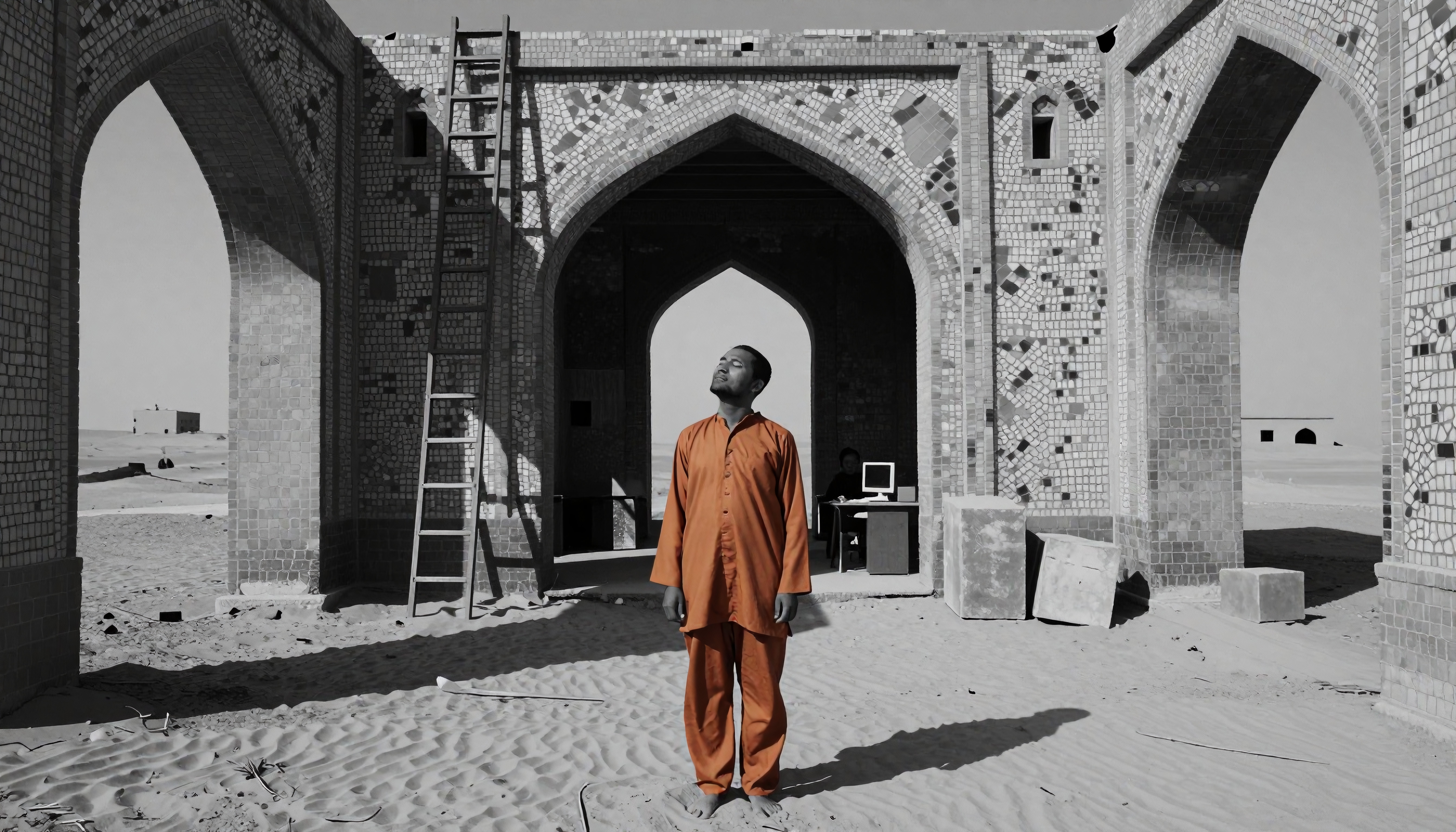 A person in orange stands in a mosaic-patterned stone structure surrounded by sand, symbolizing solitude in a contrasting modern and historical setting.