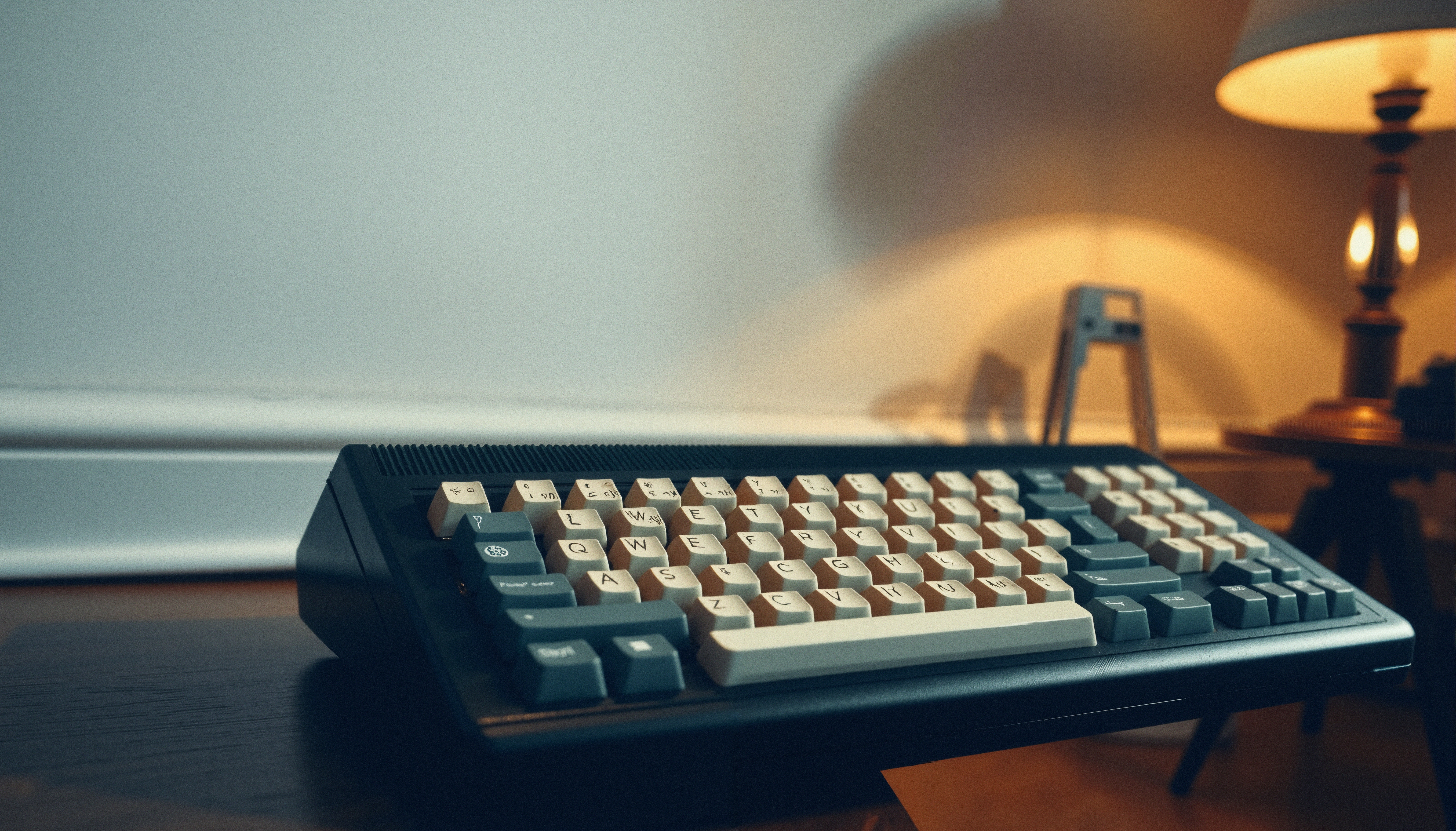 Clavicorn Mechanical Keyboard on a Desk with Warm Ambient Lighti