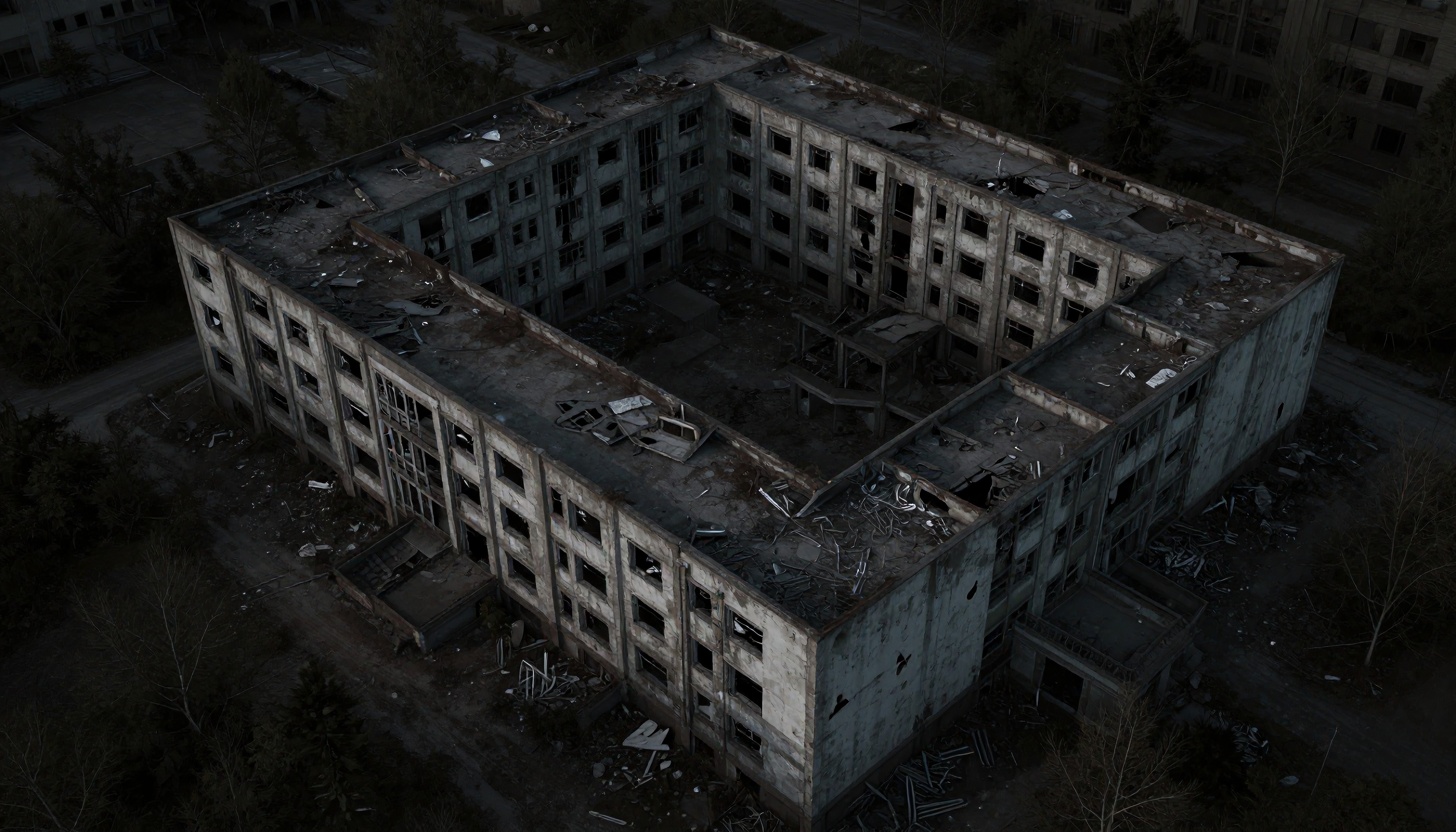 Aerial view of abandoned, dilapidated building with debris.
