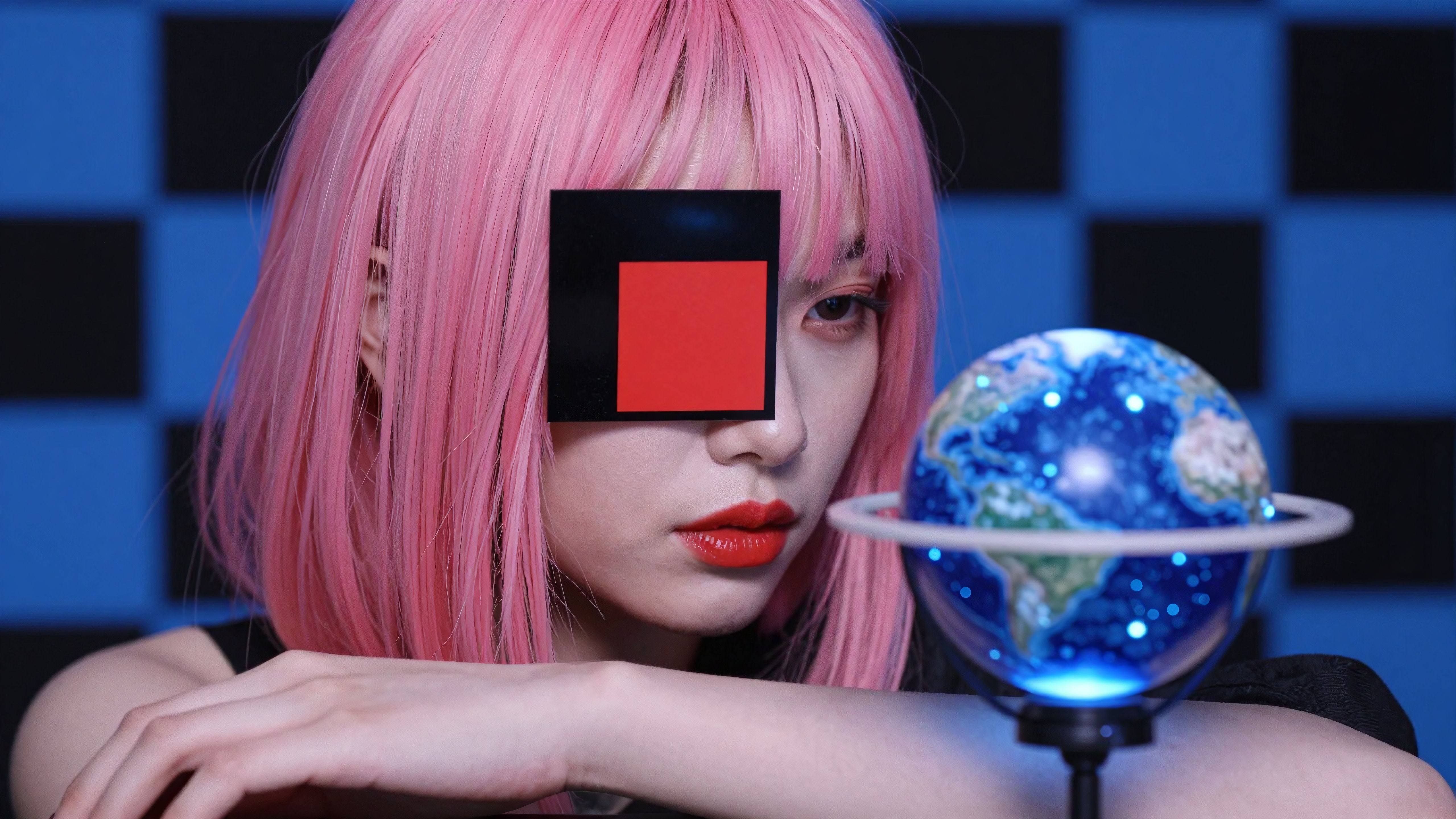 Woman with pink wig holding glowing Earth globe in futuristic blue room