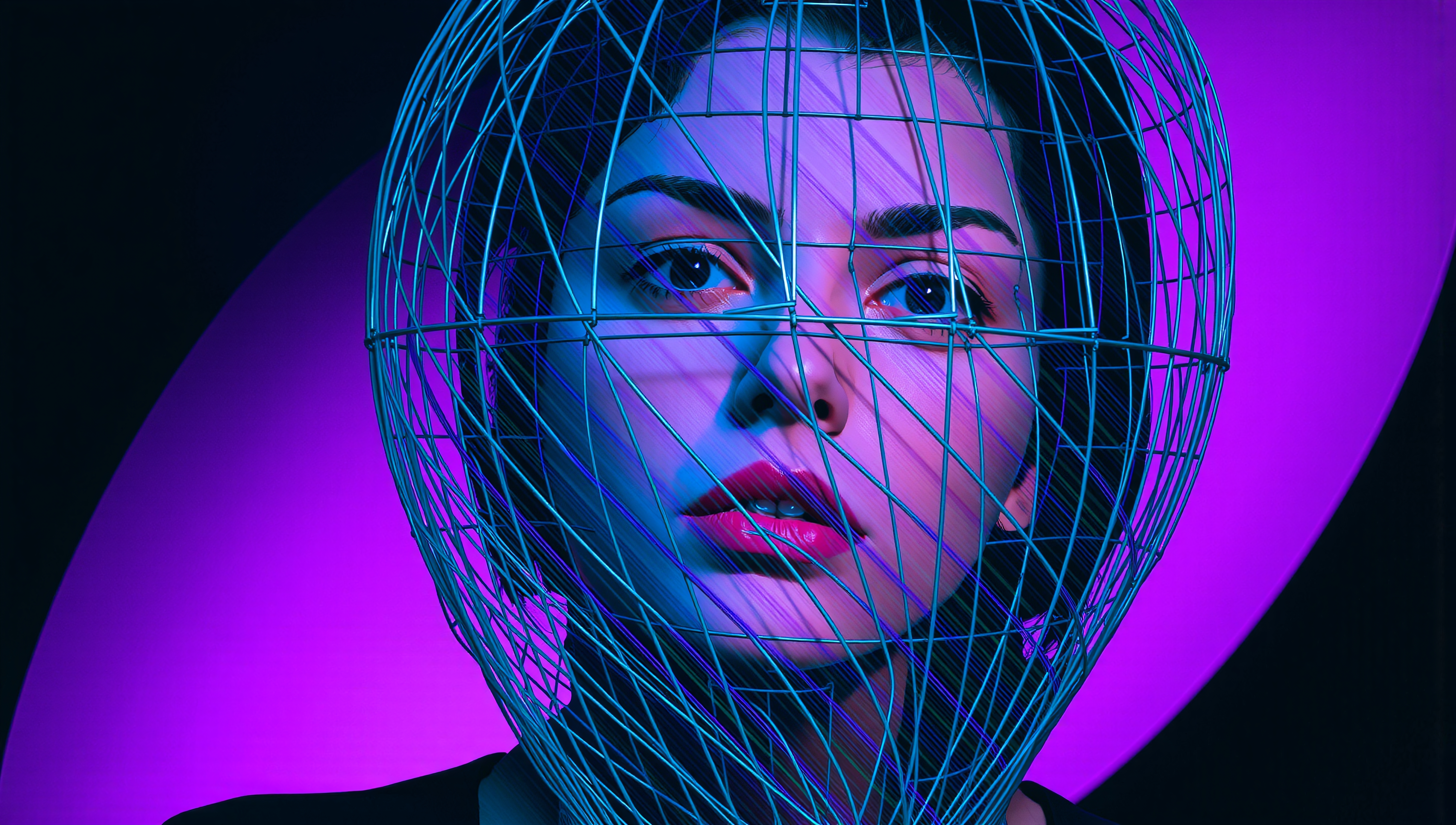 A woman gazes through a wireframe helmet under blue and pink neon lights, creating a futuristic and artistic portrait.