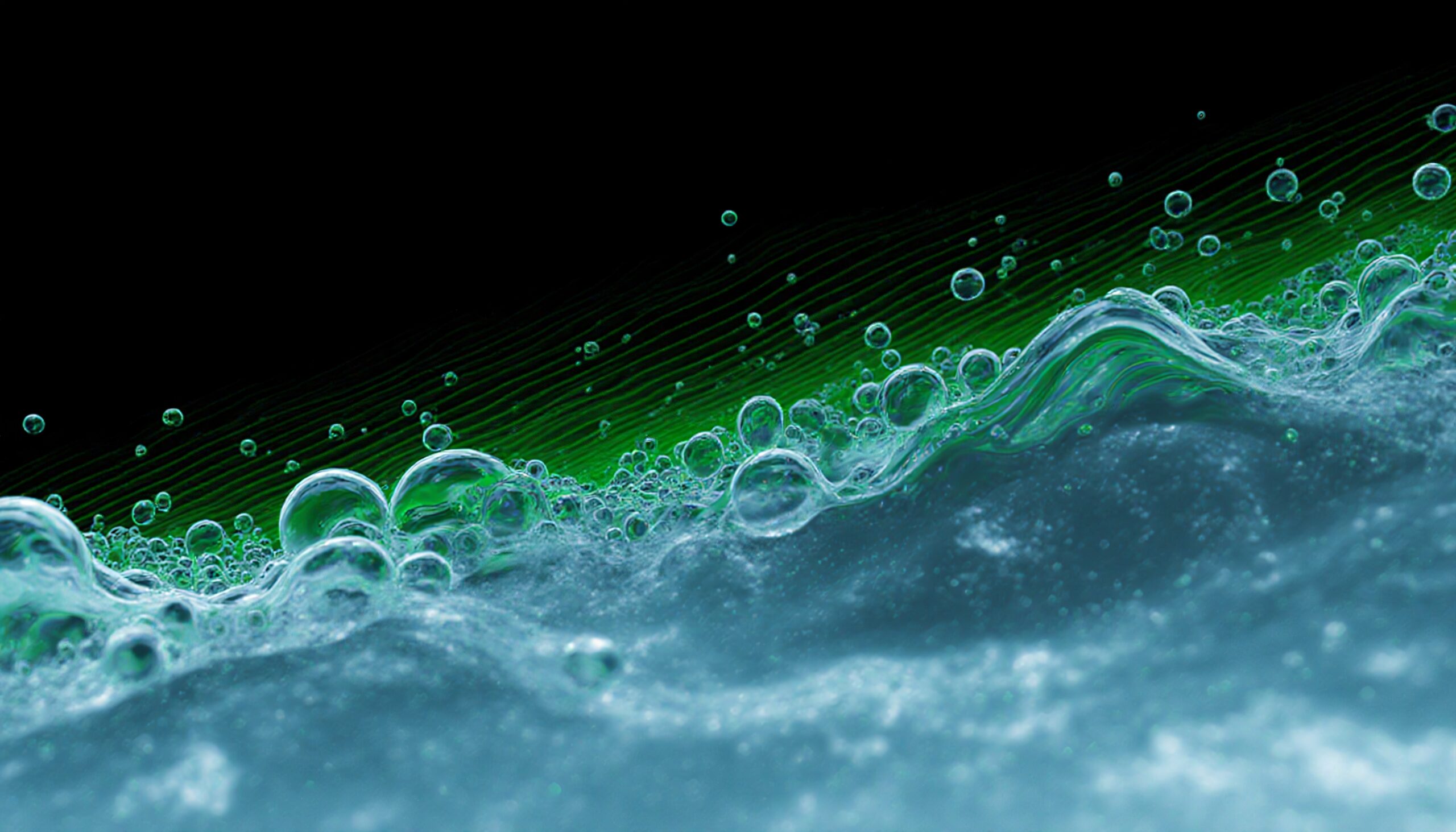 An abstract image of translucent bubbles with green hues on a dark background.