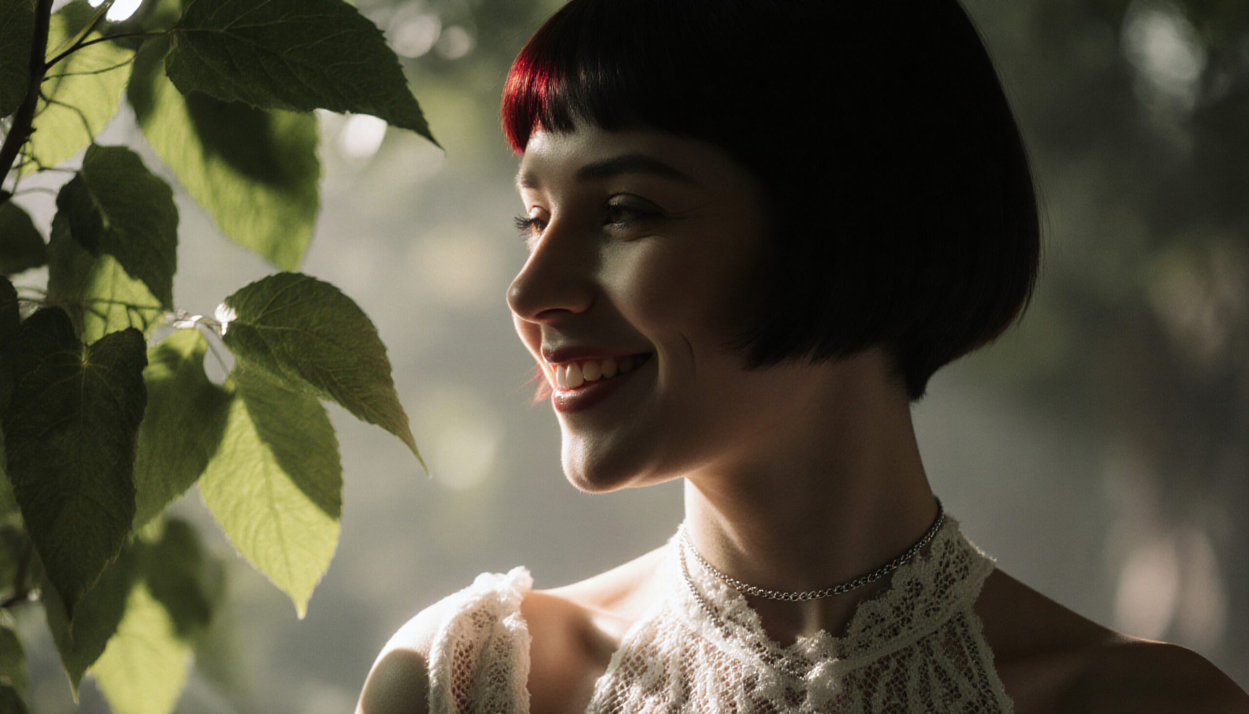 Young woman smiling in nature with sunlight illuminating her face and lace attire.